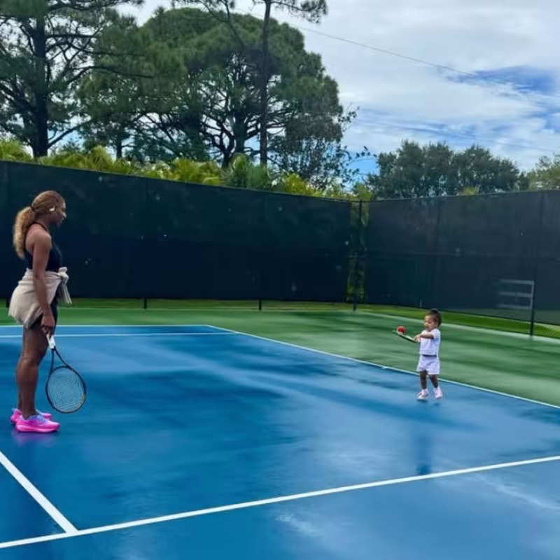 The heartfelt image of Serena Williams with her young daughter on the courts. Photo: Getty